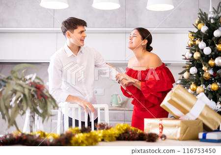 Conflict of a married couple during Christmas holiday - husband and wife yell at each other Conflict of a married couple during Christmas holiday - husband and wife yell at each other 116753450