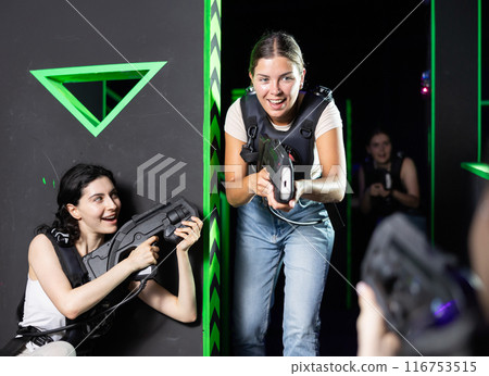 Girls play laser tag, jokingly fight with light weapons 116753515