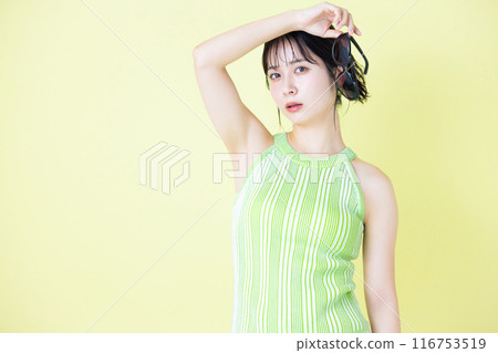 Summer image: Young woman holding sunglasses 116753519