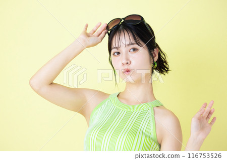 Summer image: Young woman holding sunglasses 116753526