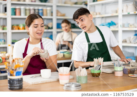 Young woman and young man making pottery 116753529