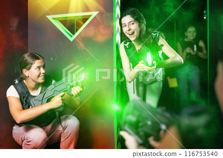 Girls play laser tag, jokingly fight with light weapons 116753540
