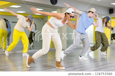 Young girl in cap dancing hip hop 116753560