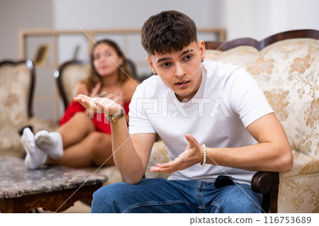 Unhappy woman quarrelling with husband at home interior 116753689