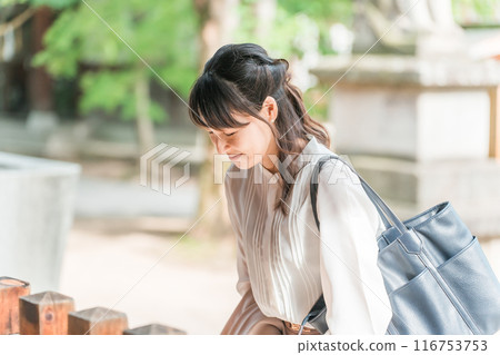 Asian business woman walking in a power spot/shrine Asian business woman walking in a power spot/shrine 116753753