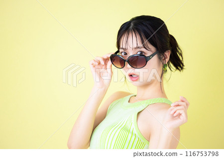 Summer image, yellow background, portrait of a young woman wearing a tank top 116753798