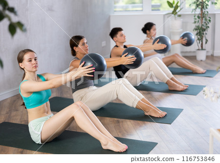 Girl participates in group lesson with sof tball, modern sport in studio. 116753846