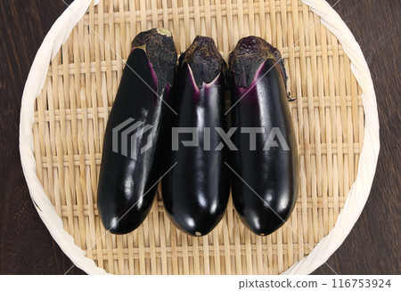 Fresh eggplant in a colander 116753924