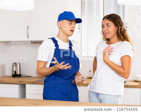 Young landlady explains her problem to a guy plumber Young landlady explains her problem to a guy plumber 116754105
