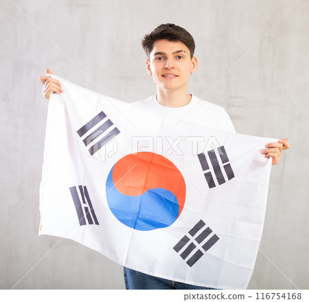 Male fan of favorite team of South Korea with the national flag in her hands Male fan of favorite team of South Korea with the national flag in her hands 116754168
