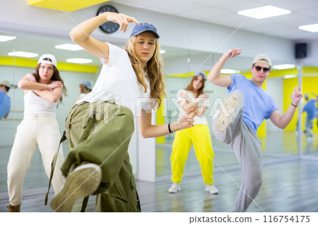 Teen girl in cap dancing modern dances 116754175