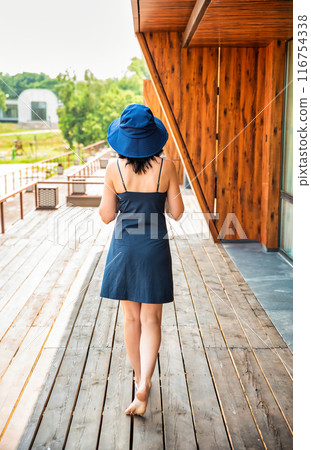 50 years old russian woman in short dress holding her hat on the sumer day 50 years old russian woman in short dress holding her hat on the sumer day 116754338