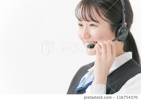 A woman in office clothes wearing a headset 116754370