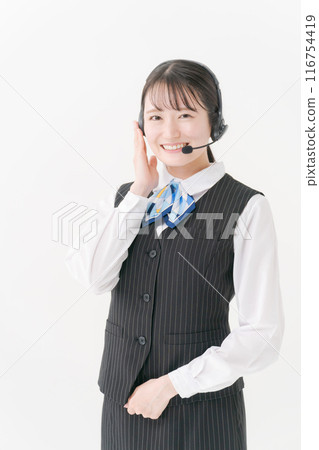 A woman in office clothes wearing a headset 116754419