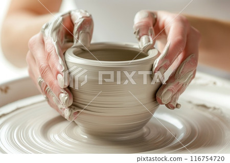 Hands of girl creating bowl on potter's wheel 116754720