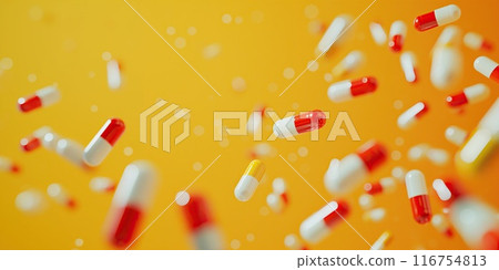 Red and white capsules falling on a yellow background. Medical concept 116754813