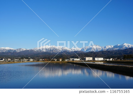 The Tateyama mountain range reflected in rice paddies as seen from Tateyama Town, Toyama Prefecture The Tateyama mountain range reflected in rice paddies as seen from Tateyama Town, Toyama Prefecture 116755165
