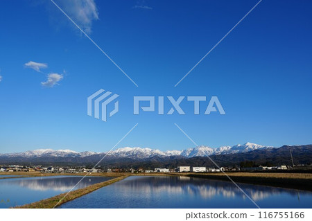 The Tateyama mountain range reflected in rice paddies as seen from Tateyama Town, Toyama Prefecture The Tateyama mountain range reflected in rice paddies as seen from Tateyama Town, Toyama Prefecture 116755166