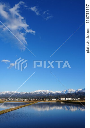 The Tateyama mountain range reflected in rice paddies as seen from Tateyama Town, Toyama Prefecture The Tateyama mountain range reflected in rice paddies as seen from Tateyama Town, Toyama Prefecture 116755167