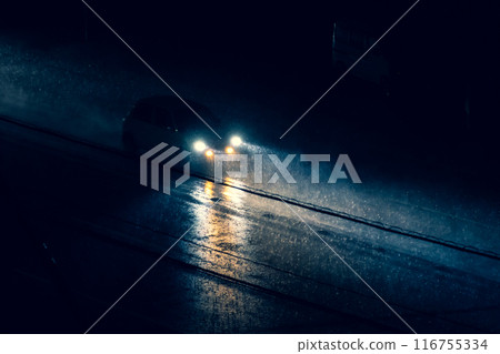 Cars driving on a road with poor visibility at night during heavy rain b-2 Warm and cool colors 116755334