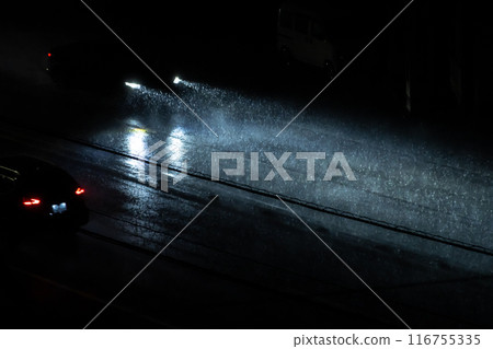 A car driving on a road with poor visibility during a heavy rainy night c-1 116755335