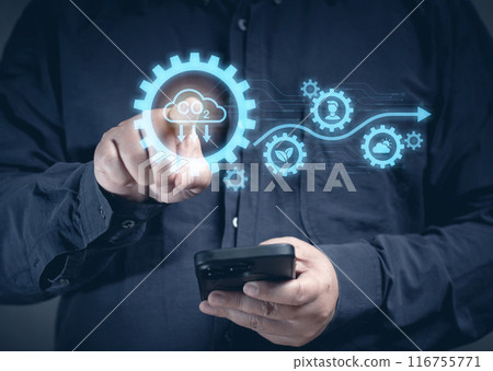 A man uses a mobile phone to order tasks to check carbon climate sustainable on the virtual screen. Eco earth environment and pollution change. Global economy renewable strategy in future. 116755771
