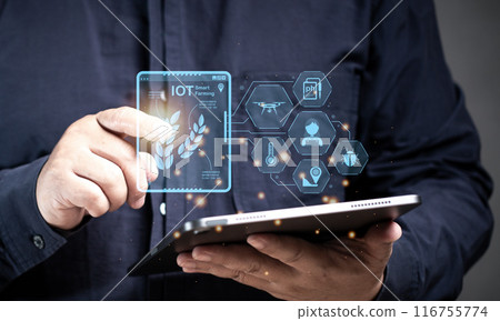 Man point the IoT Smart farm on the tablet virtual screen. Application for farmer innovation to check and control for farming growth harvest online. AI, artificial intelligence systems management. 116755774