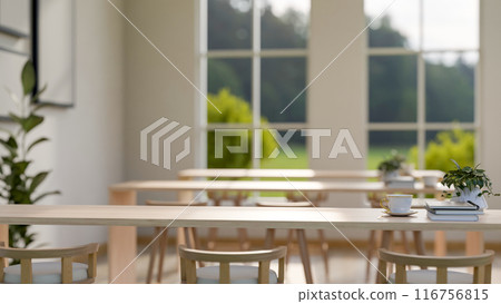 A copy space on a wooden tabletop in a comfortable, minimalist shared reading room or library. 116756815