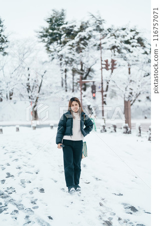 Traveler with Sweater and backpack walking on snow covered forest in frosty weather. Winter Travel, Adventure, Exploring and Vacation concept Traveler with Sweater and backpack walking on snow covered forest in frosty weather. Winter Travel, Adventure, Exploring and Vacation concept 116757071