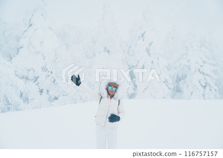 Woman tourist sightseeing Snow monster in Winter day at Mount Zao, Yamagata prefecture, Japan. Happy Traveler walking on powder snow covered in frosty weather. Travel, Adventure and Vacation 116757157