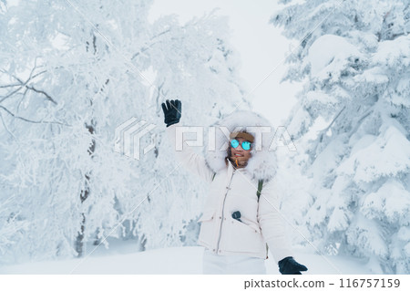 Woman tourist sightseeing Snow monster in Winter day at Mount Zao, Yamagata prefecture, Japan. Happy Traveler walking on powder snow covered in frosty weather. Travel, Adventure and Vacation Woman tourist sightseeing Snow monster in Winter day at Mount Zao, Yamagata prefecture, Japan. Happy Traveler walking on powder snow covered in frosty weather. Travel, Adventure and Vacation 116757159