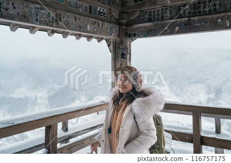 Woman tourist sightseeing view of village with snow in winter from mountain viewpoint of Yamadera temple or Risshakuji temple located in Yamagata City, in Yamagata Prefecture, Tohuku, Japan Woman tourist sightseeing view of village with snow in winter from mountain viewpoint of Yamadera temple or Risshakuji temple located in Yamagata City, in Yamagata Prefecture, Tohuku, Japan 116757175
