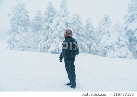 man tourist sightseeing Snow monster in Winter day at Mount Zao, Yamagata prefecture, Japan. Happy Traveler walking on powder snow covered in frosty weather. Travel, Adventure and Vacation man tourist sightseeing Snow monster in Winter day at Mount Zao, Yamagata prefecture, Japan. Happy Traveler walking on powder snow covered in frosty weather. Travel, Adventure and Vacation 116757196