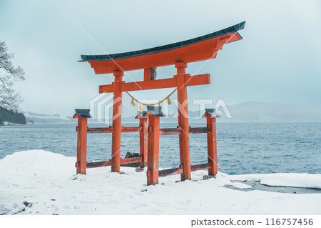 Red Japanese Torii gate of Goza no Ishi Shrine at lake tazawa in winter, located in Semboku city, Akita Prefecture, northern Japan. Landmark and famous for tourists attractions in Tohoku region, Japan Red Japanese Torii gate of Goza no Ishi Shrine at lake tazawa in winter, located in Semboku city, Akita Prefecture, northern Japan. Landmark and famous for tourists attractions in Tohoku region, Japan 116757456