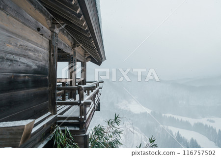 view of village with snow in winter from mountain viewpoint of Yamadera temple, the popular name for the Buddhist temple of Risshakuji located in Yamagata City, in Yamagata Prefecture, Tohuku, Japan 116757502