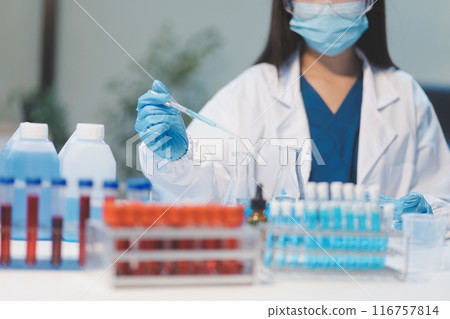 Group of dedicated scientist conduct chemical experiment in medical laboratory, carefully drop precise amount of liquid from pipette into test tube for vaccine drug or antibiotic development. Neoteric Group of dedicated scientist conduct chemical experiment in medical laboratory, carefully drop precise amount of liquid from pipette into test tube for vaccine drug or antibiotic development. Neoteric 116757814
