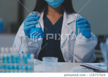 Group of dedicated scientist conduct chemical experiment in medical laboratory, carefully drop precise amount of liquid from pipette into test tube for vaccine drug or antibiotic development. Neoteric Group of dedicated scientist conduct chemical experiment in medical laboratory, carefully drop precise amount of liquid from pipette into test tube for vaccine drug or antibiotic development. Neoteric 116757820