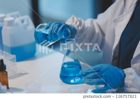 Group of dedicated scientist conduct chemical experiment in medical laboratory, carefully drop precise amount of liquid from pipette into test tube for vaccine drug or antibiotic development. Neoteric Group of dedicated scientist conduct chemical experiment in medical laboratory, carefully drop precise amount of liquid from pipette into test tube for vaccine drug or antibiotic development. Neoteric 116757821