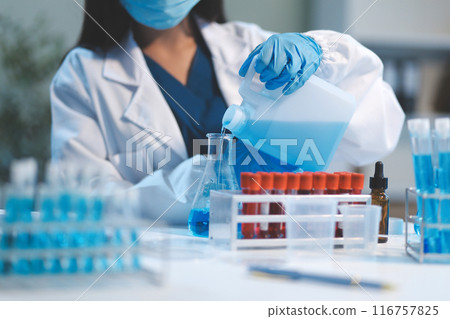Group of dedicated scientist conduct chemical experiment in medical laboratory, carefully drop precise amount of liquid from pipette into test tube for vaccine drug or antibiotic development. Neoteric Group of dedicated scientist conduct chemical experiment in medical laboratory, carefully drop precise amount of liquid from pipette into test tube for vaccine drug or antibiotic development. Neoteric 116757825