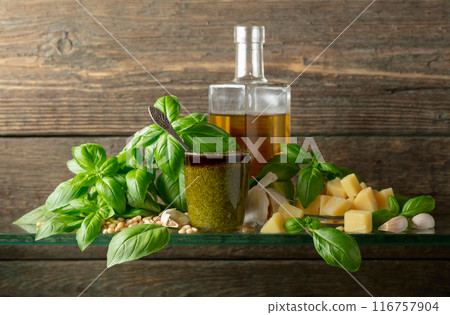 Pesto sauce and ingredients on a old wooden background. 116757904