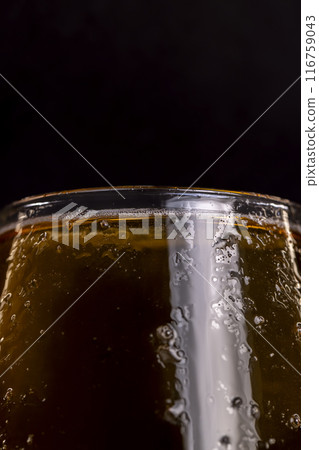 light golden beer in a glass glass on a black background 116759043