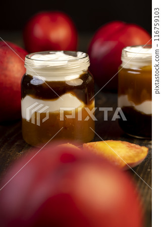 fresh yogurt with jam and pieces of ripe nectarine fresh yogurt with jam and pieces of ripe nectarine 116759103