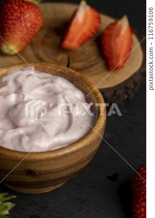 yogurt made from milk with added flavor and pieces of ripe strawberries yogurt made from milk with added flavor and pieces of ripe strawberries 116759106