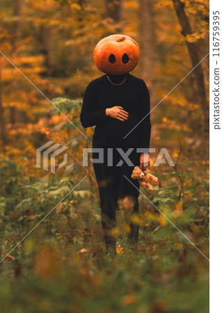 pregnant woman with pumpkin head halloween costume 116759395