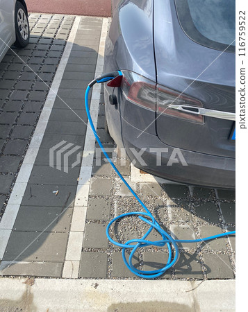 Electric car charging at public station Electric car charging at public station 116759522