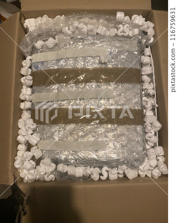 Packing a laptop carefully for moving or shipping 116759631