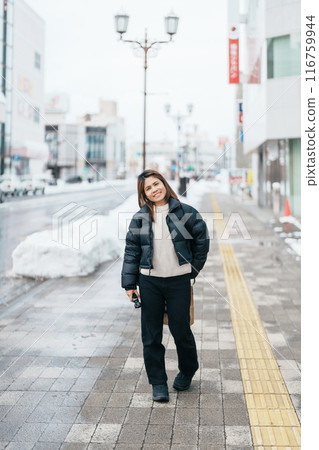 Woman tourist sightseeing Hirosaki city in winter season. Traveler travel Hirosaki Castle in Hirosaki city, Aomori Prefecture, Tohoku, Japan. Landmark for tourist attraction, travel and vacation Woman tourist sightseeing Hirosaki city in winter season. Traveler travel Hirosaki Castle in Hirosaki city, Aomori Prefecture, Tohoku, Japan. Landmark for tourist attraction, travel and vacation 116759944