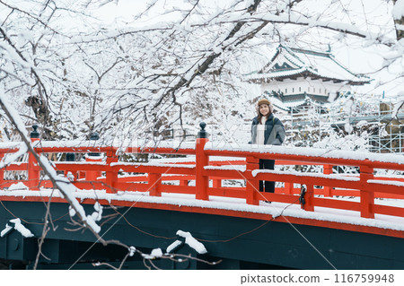 Woman tourist sightseeing Hirosaki Castle in winter, happy traveler travel Hirosaki city, Aomori Prefecture, Tohoku, Japan. Landmark and famous for tourist attraction. Japan travel and vacation Woman tourist sightseeing Hirosaki Castle in winter, happy traveler travel Hirosaki city, Aomori Prefecture, Tohoku, Japan. Landmark and famous for tourist attraction. Japan travel and vacation 116759948