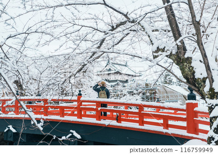 Woman tourist sightseeing Hirosaki Castle in winter, happy traveler travel Hirosaki city, Aomori Prefecture, Tohoku, Japan. Landmark and famous for tourist attraction. Japan travel and vacation Woman tourist sightseeing Hirosaki Castle in winter, happy traveler travel Hirosaki city, Aomori Prefecture, Tohoku, Japan. Landmark and famous for tourist attraction. Japan travel and vacation 116759949
