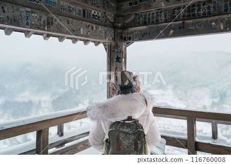 Woman tourist sightseeing view of village with snow in winter from mountain viewpoint of Yamadera temple or Risshakuji temple located in Yamagata City, in Yamagata Prefecture, Tohuku, Japan Woman tourist sightseeing view of village with snow in winter from mountain viewpoint of Yamadera temple or Risshakuji temple located in Yamagata City, in Yamagata Prefecture, Tohuku, Japan 116760008